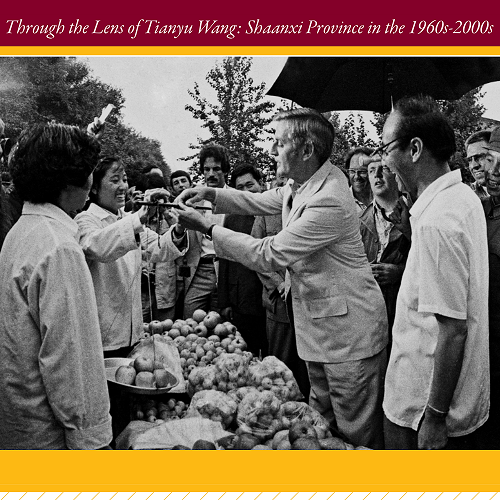 Black-and-white photograph of people gathered at an outdoor market, featured in the exhibit ‘Through the Lens of Tianyu Wang: Shaanxi Province in the 1960s–2000s.