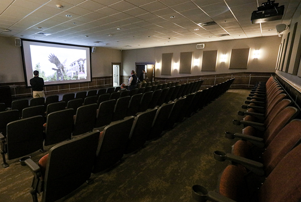 theatre with large screen, seating, and av