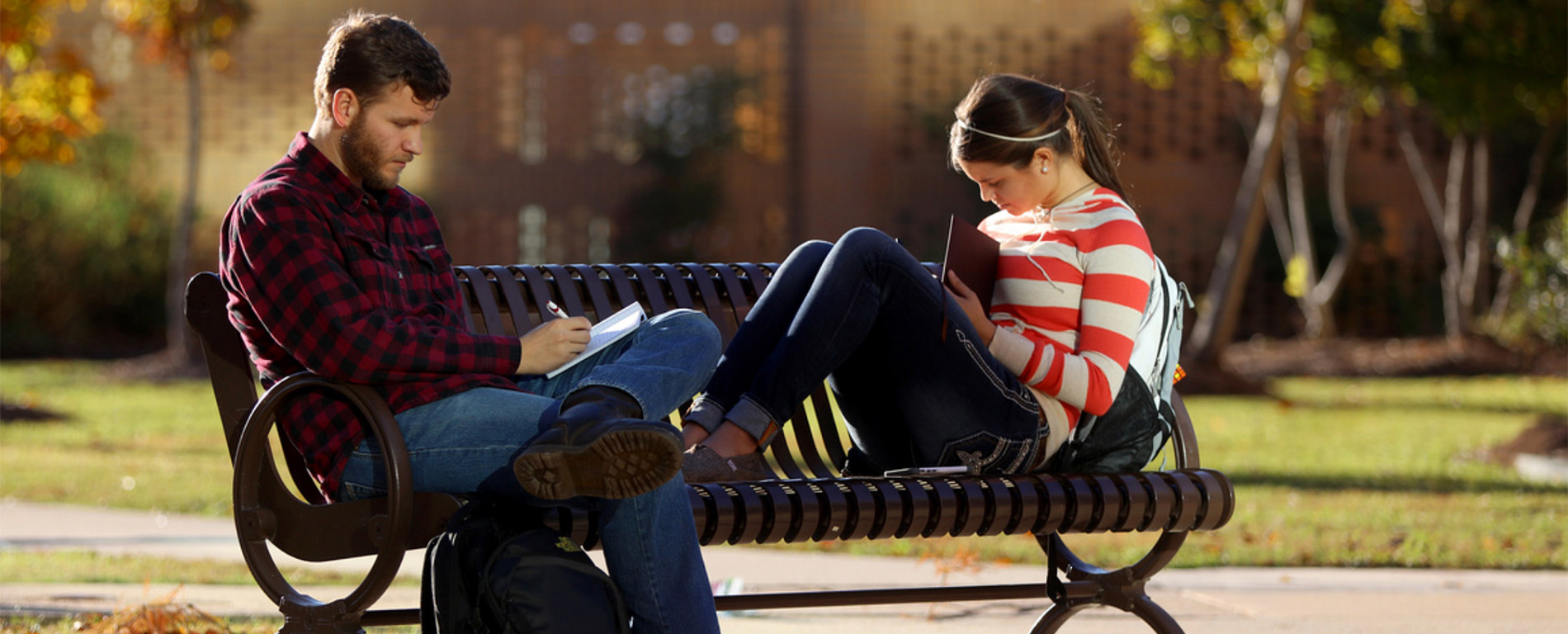 students on park bench studying