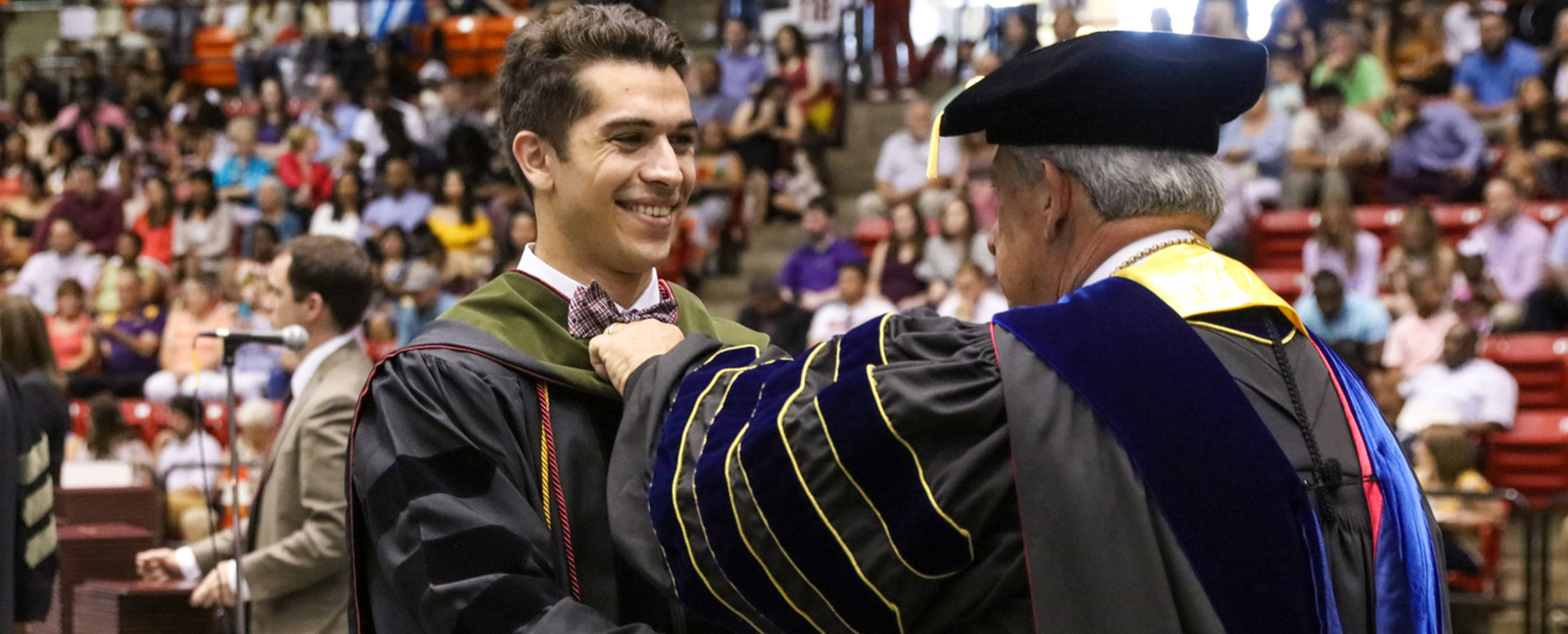 Doctoral Graduate receiving diploma at commencement