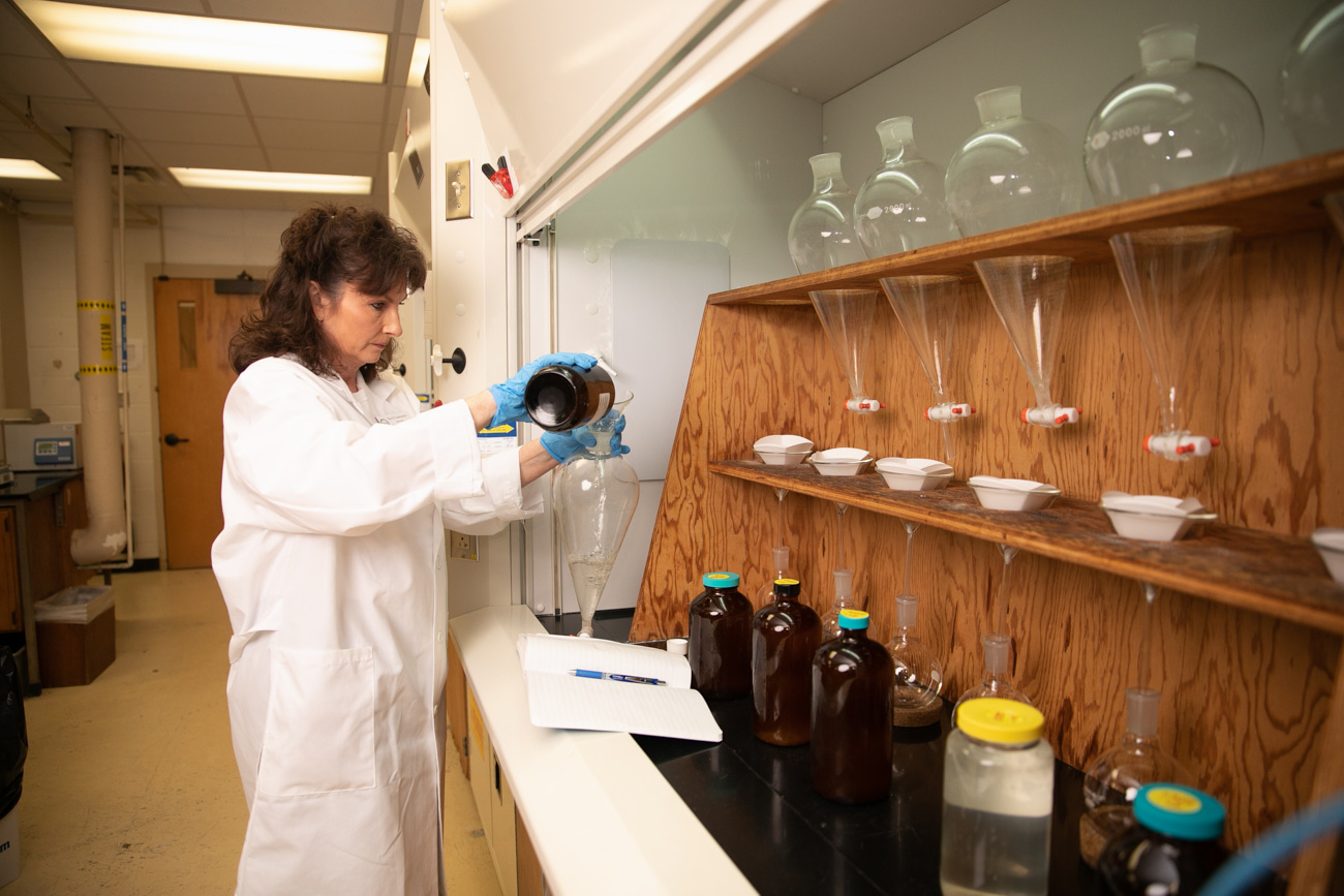 Terri Lancaster, director of the ULM Environmental Analysis Lab, examines materials at the laboratory. 