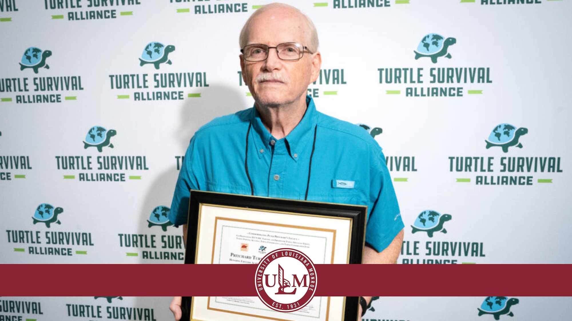 Dr. John Carr poses with his Pritchard Lifetime Achievement Award