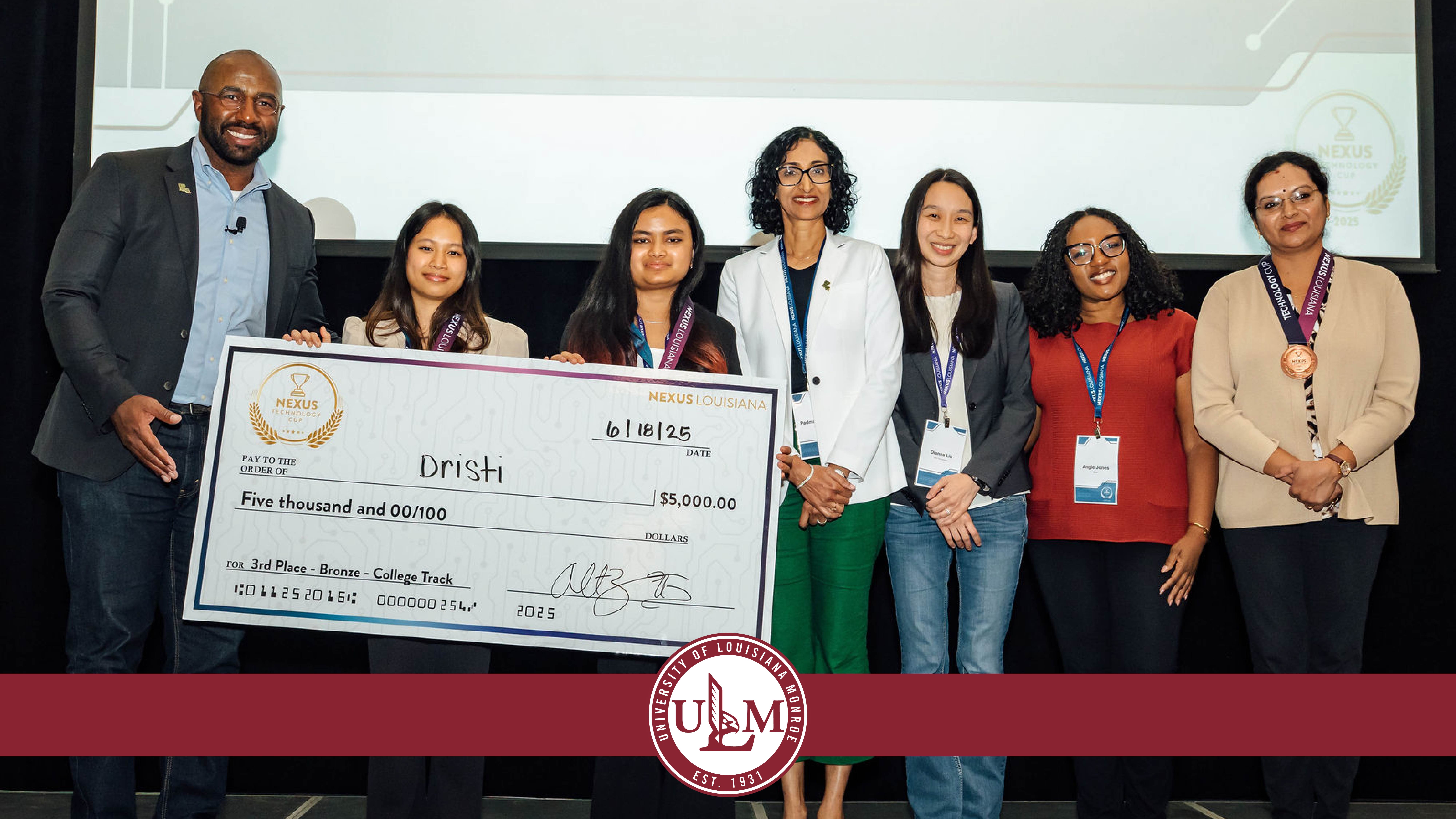 A group of people pose with a large check for $5,000.