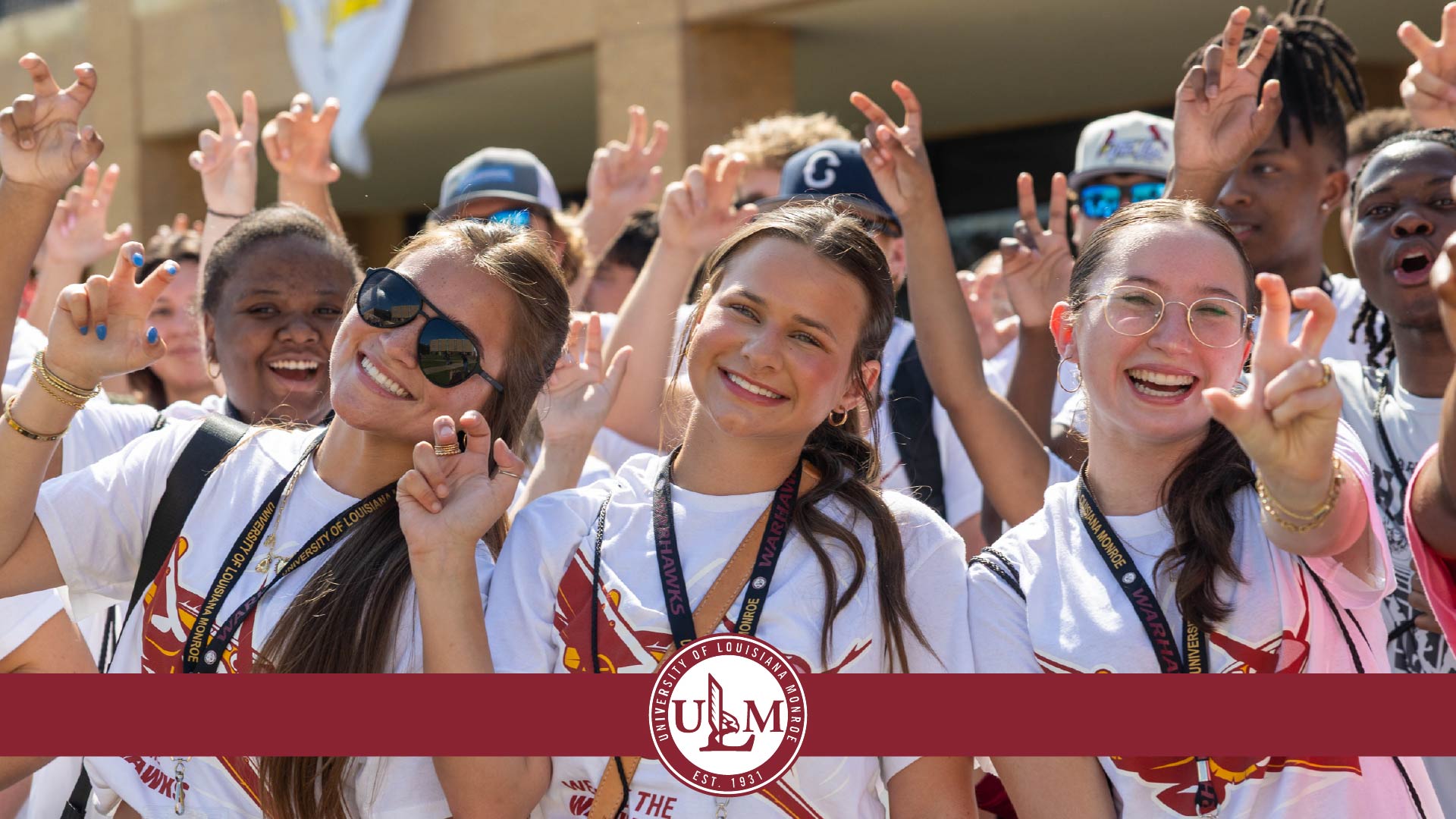 A group of students at PREP, freshman orientation, giving the "talons out" hand sign. 