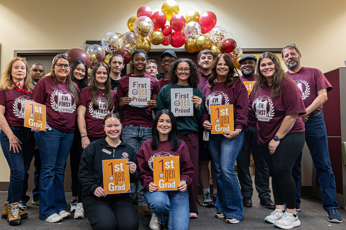 A group of people pose and smile for TRIO first-generation day