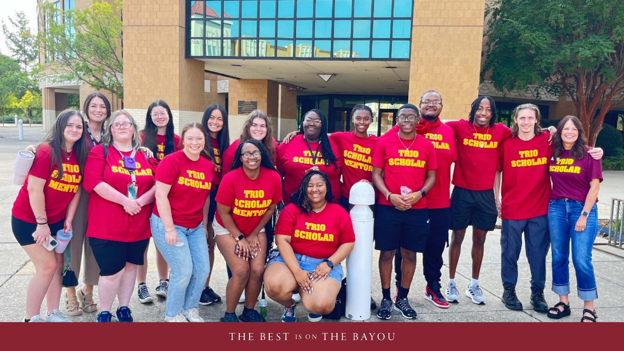 A group of students and staff pose and smile while attending the WINGS camp. 