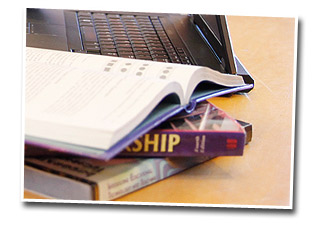 photo of laptop and books