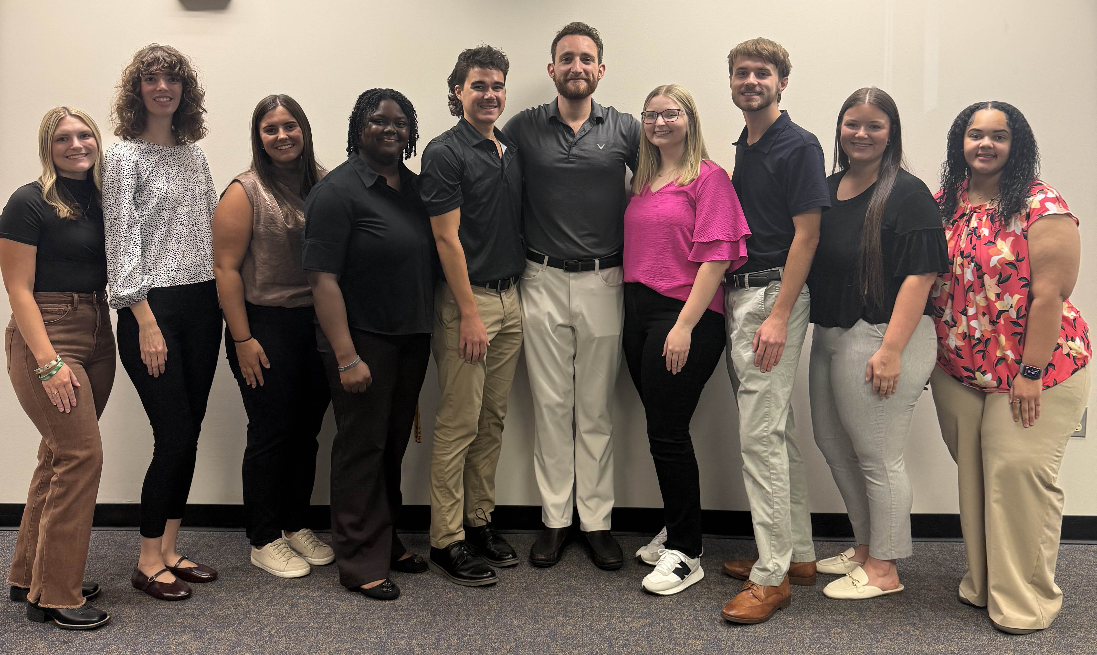 ULM COP SNPhA's ten officers for 2026 in front of the beige wall.