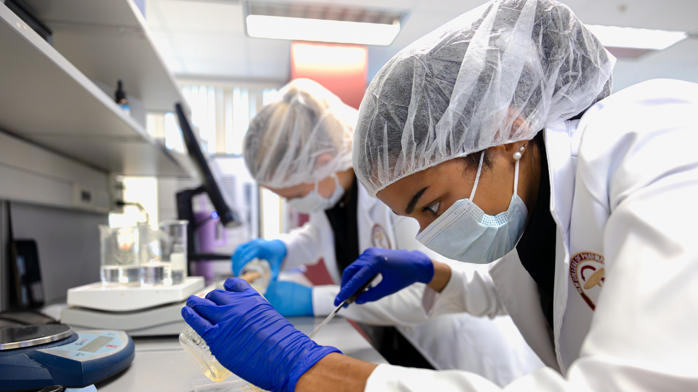 Stock photo of two students working in pharmacy lab for Future Pharmacists Club