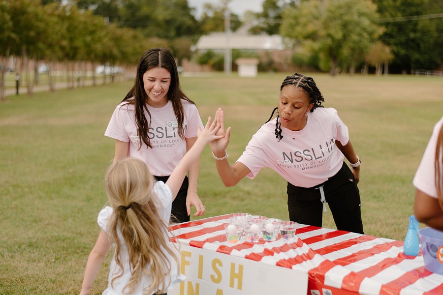 student and young client at field day